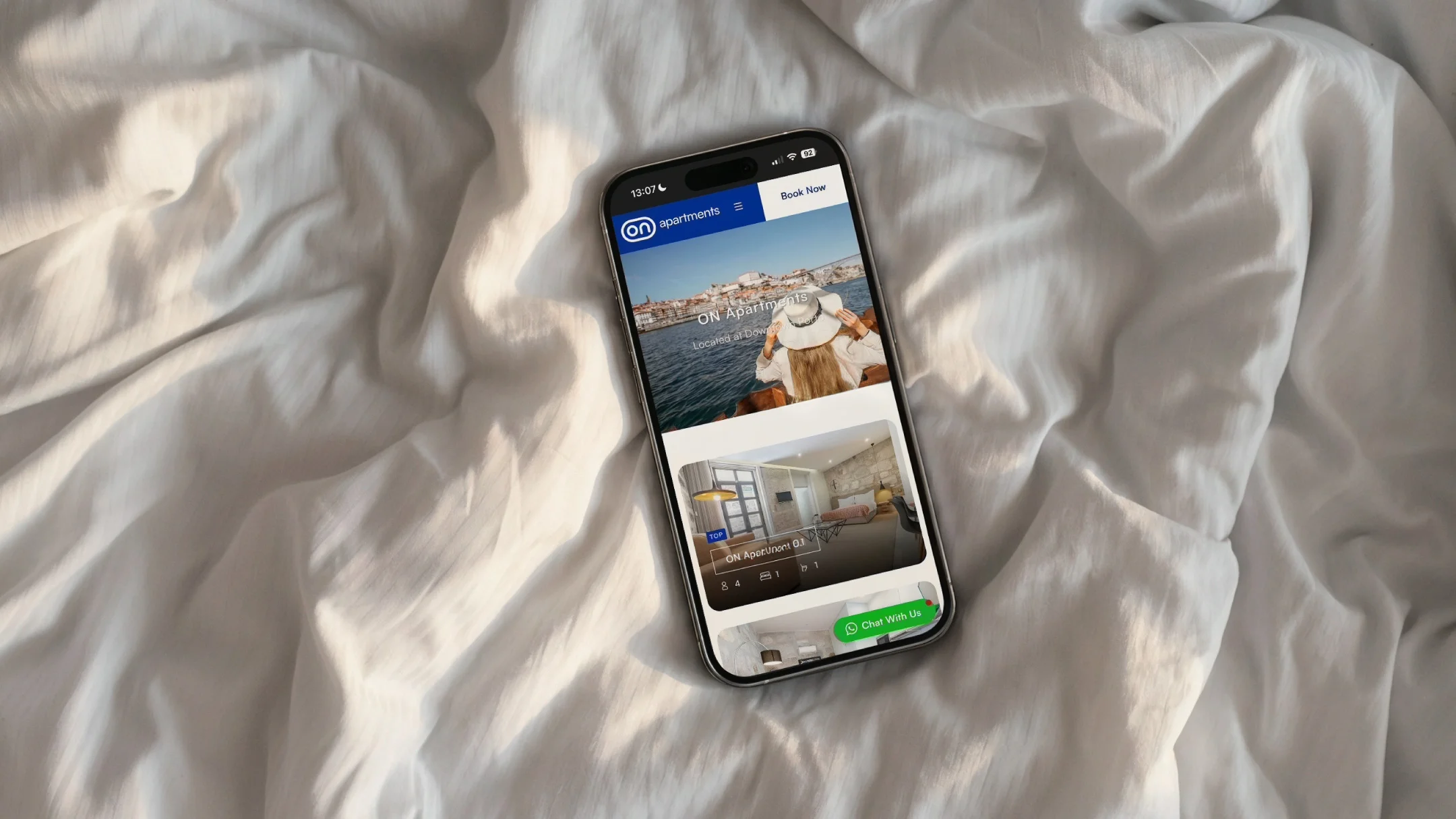 Nhdesign project ON Apartments: Phone showing the ON website in a lifestyle setting, conveying comfort and the stay experience